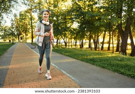 Strong woman running on countryside