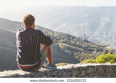 Similar – Image, Stock Photo Anonymous traveler admiring landscape of volcano under cloudy sky