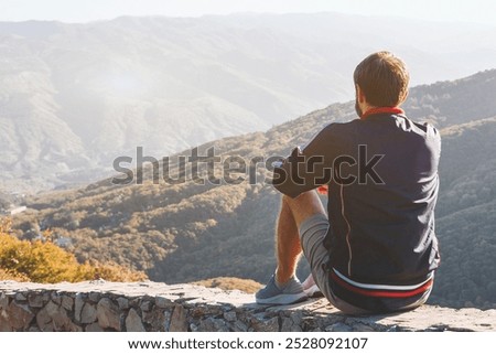 Similar – Image, Stock Photo Anonymous traveler admiring landscape of volcano under cloudy sky