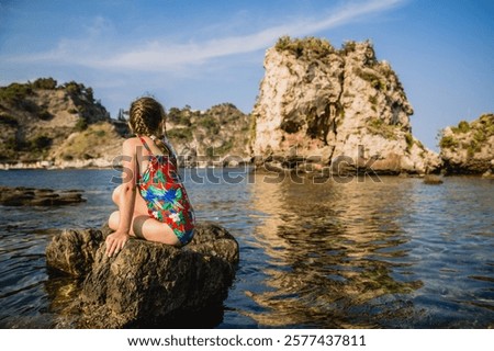 Similar – Image, Stock Photo Coastal landscape and girl in yellow hooded coat looking at sea and walking. Copy space.