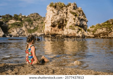 Similar – Image, Stock Photo Coastal landscape and girl in yellow hooded coat looking at sea and walking. Copy space.