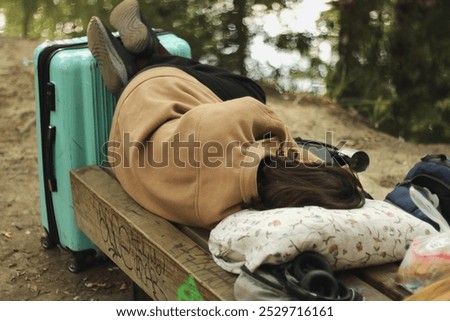 Similar – Image, Stock Photo Tired female traveler sleeping on airport.