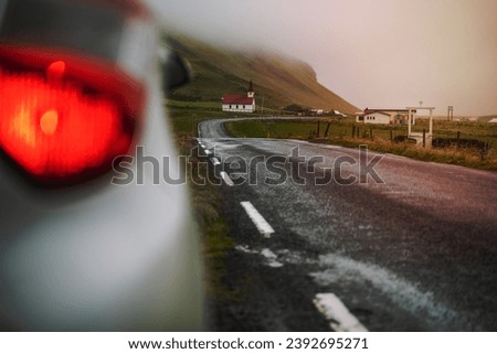 Similar – Image, Stock Photo Car stoped on the road with view of typical rural Icelandic Church with red roof in Vik region. Iceland