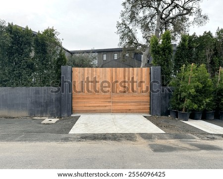 Similar – Image, Stock Photo large wooden gate with plain door handle, slanted wooden boards and painted with different green paint, which is peeling off