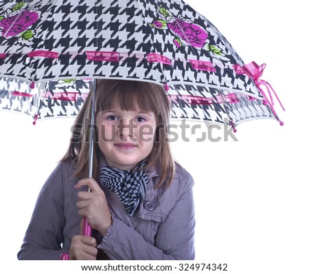 Teen girl in raincoat under beautiful umbrella shows on rain  isolated white