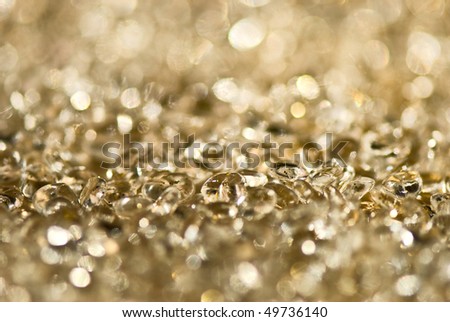 Gold background with a line of transparent droplets