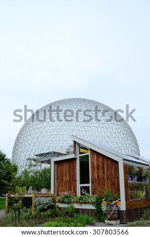 MONTREAL, CANADA JULY 2009 - Eco house in Parc Jean-Drapeau with Buckminster Fullers geodesic dome from the 1967 world expo in the background circa 2009 in Montreal.