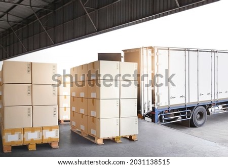 Industry Cargo Freight Trucks Transport and Logistics. Cargo Container Truck Parked Loading Package Boxes at the Warehouse. Supply Chain. Distribution Warehouse Center. Shipping Shipment Cargo.