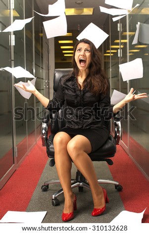 Beautiful brunette woman scream and throw paper in office on the chair