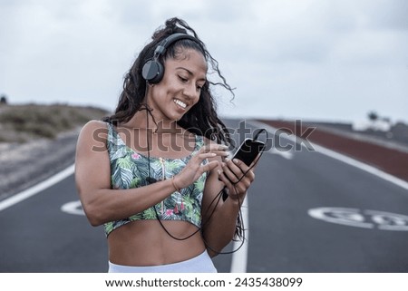 Similar – Foto Bild Fröhliche ethnische Sportlerin beim Headset-Training am Stadtfluss