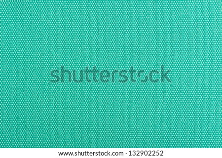 A close-up of turquoise fabric background texture