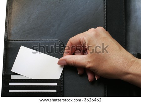 using a black leather portfolio (also called a folder), a woman displays blank business cards