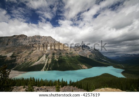 aqua waters of scenic Peyto Lake shimmer in the bright sunlight