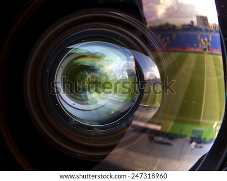 reflection and glare in the lens of the television camera.