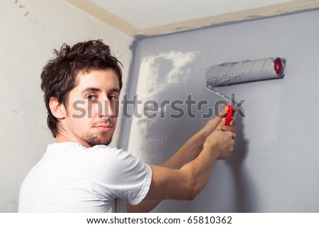 Young man painting the wall