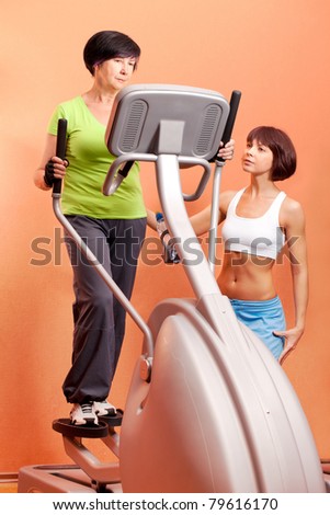 Adorable lady on cardio machine in the gym