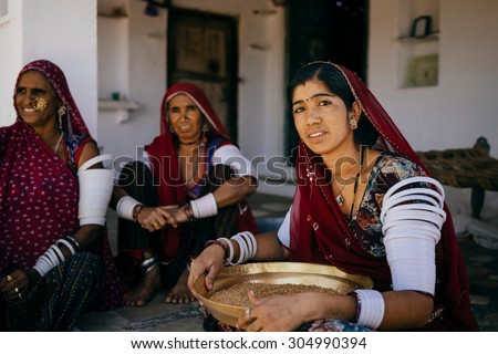 JAISALMER - MARCH 20 : women preparing food in mud hut on March 20 , 2014 in Jaisalmer,India