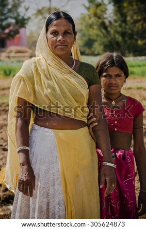 UDAIPUR - MARCH 25 : woman and daughter posing in the street on March 25 , 2014 in Udaipur,India