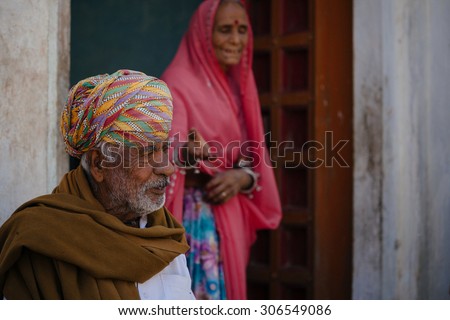 JAISALMER - MARCH 22 : women and man posing in front of their house on March 22 , 2014 in Jaisalmer,India