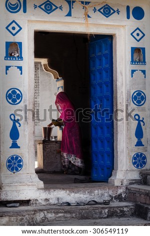 JAISALMER - MARCH 23 : women posing in front of her house on March 23 , 2014 in Jaisalmer,India