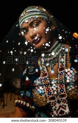 JAISALMER, INDIA - MARCH 22 : Indian woman poses in the desert on March 22, 2014 in Jaisalmer, India
