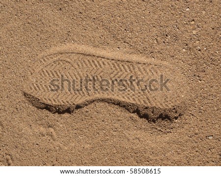 Color photo of a trace of shoe in sand
