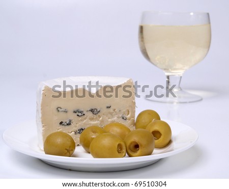 Color photo of green olives on a white plate