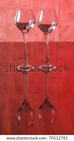 Color photo of a glass of red wine glasses on the mirror surface