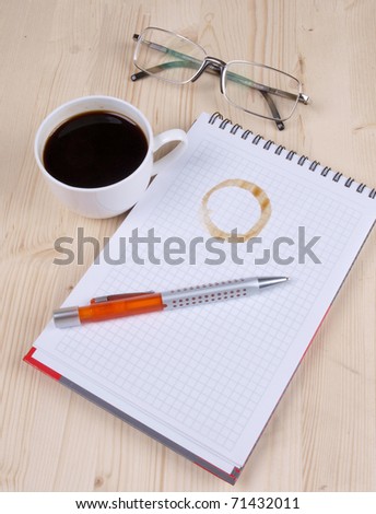 Color photo of paper page and a white cup