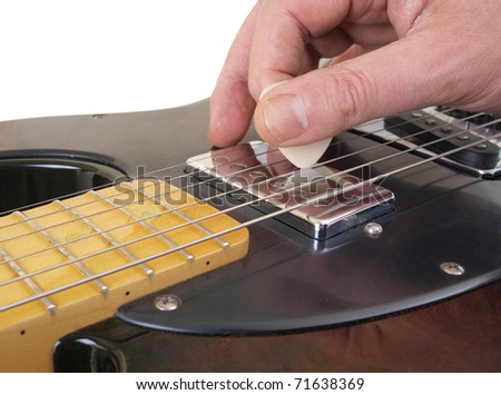 Color photo of electric guitar and pick