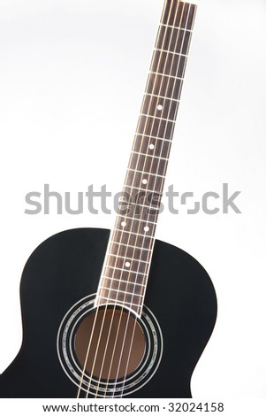 A black acoustic  guitar isolated against a white  background in the vertical format.