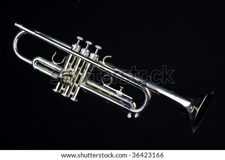 A gold brass trumpet isolated against a clean black background in the horizontal format.