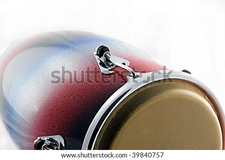 A red and blue African or latin conga drum isolated on white background in the horizontal format.