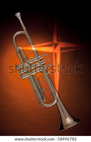 A gold trumpet or cornet with a cross against an orange background in the vertical format.