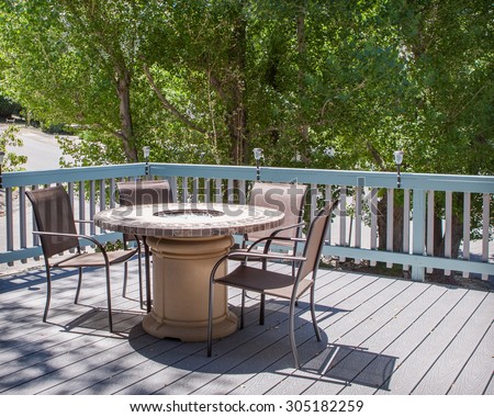 patio table with fire pit and chairs on deck