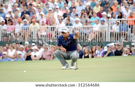 EDISON,NJ-AUGUST 30:Jason Day lines up his final putt on the 18th hole during the final round of the Barclays Tournament held at the Plainfield Country Club in Edison,NJ,August 30,2015.