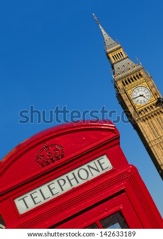 Red London phone box with Big Ben in the background.