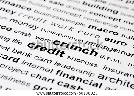 words credit and crunch in black on white background with other financial key words out of focus