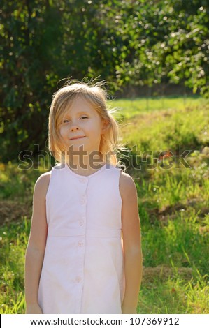 Five years old long hair girl posing outdoors