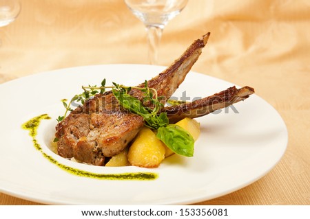 Roasted sheep meat with potatoes on dish  in restaurant