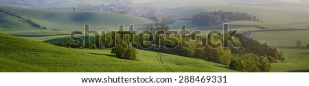 Rural  landscape with fields, waves and wooden hunting shack  - panoramic view