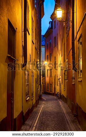 The narrow street of Gamla Stan - historic city old center of Stockholm, at summer night, with lanterns