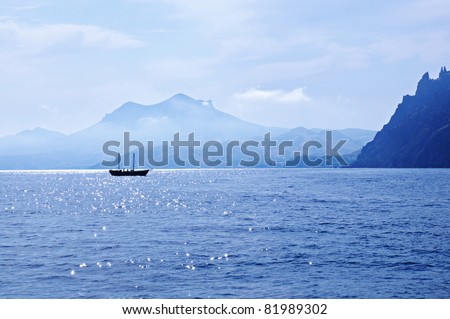 Summer landscape with sea, mountain range and ship