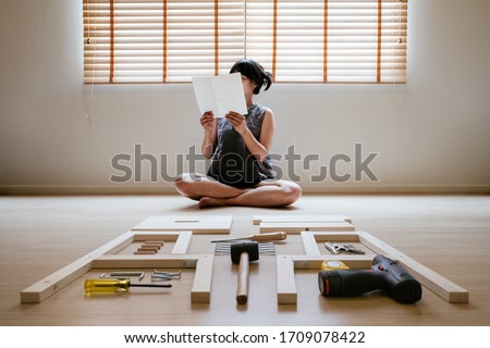 Similar – Image, Stock Photo Woman reading manual instruction to assemble furniture
