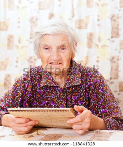 Elderly happy woman read something