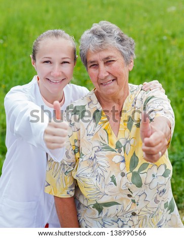 Happy elderly woman satisfied with her caretaker