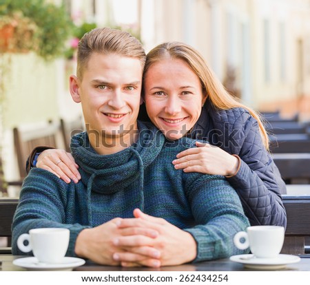 Photo of happy young couple hugging and smiling