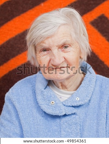 Old lonely woman staying alone at home