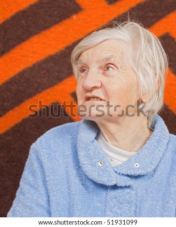 Old lonely woman staying alone at home