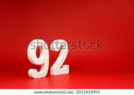 Ninety Two ( 92 ) white number wooden on Red Background with Copy Space - New promotion 92% Percentage , Birthday anniversary , Business finance Concept 